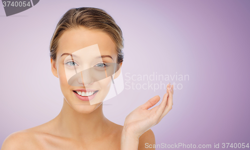 Image of smiling young woman face and shoulders