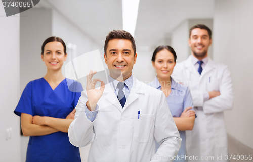 Image of group of medics at hospital showing ok hand sign