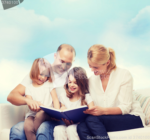 Image of happy family with book at home