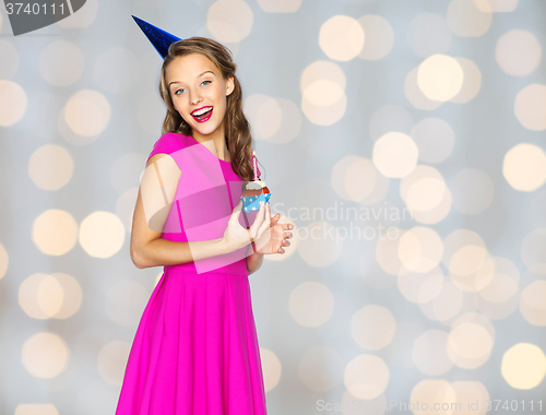 Image of happy woman or teen girl with birthday cupcake