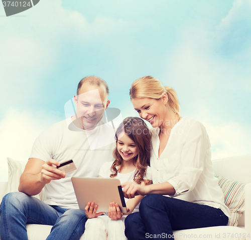 Image of happy family with tablet pc and credit card