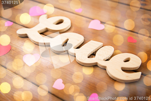 Image of close up of word love with red paper hearts