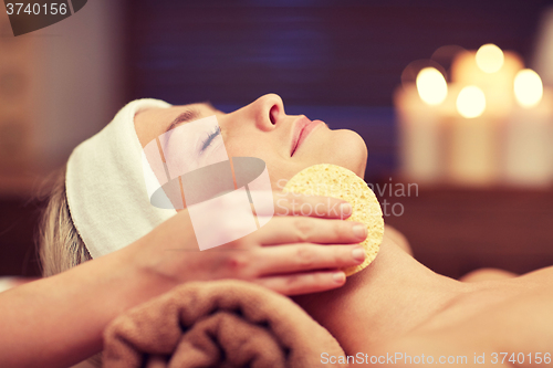 Image of close up of woman having face cleaning in spa