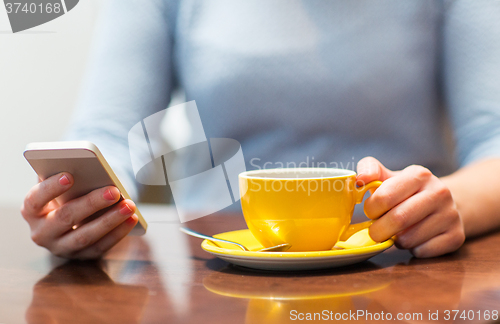 Image of close up of woman with smartphone and coffee cup