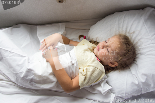 Image of Girl sleeping on a cot in a train