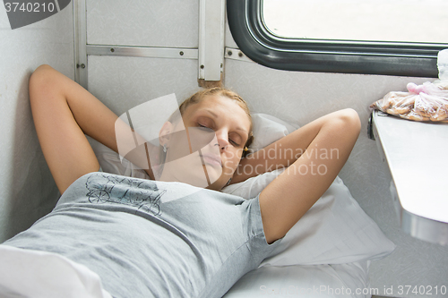 Image of Young girl sleeping on a train