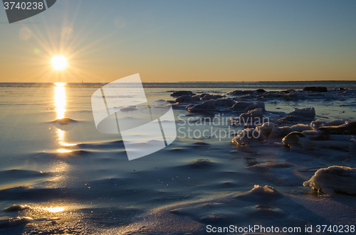 Image of Sunshine at an icy winter coast