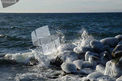 Image of Splashing water at icy rocks