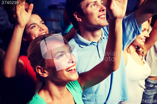 Image of smiling friends at concert in club