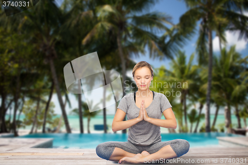 Image of woman making yoga meditation in lotus pose