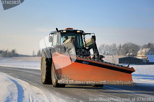 Image of Tractor and Snow Plow on the Road