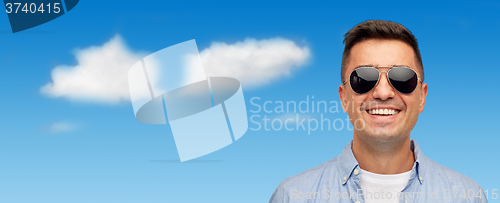 Image of face of smiling man in shirt and sunglasses