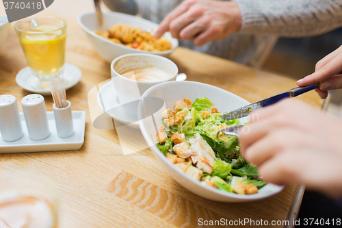 Image of close up friends having dinner at restaurant