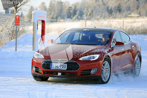 Image of Red Tesla Model S Electric Car in Winter Snow