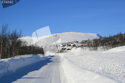Image of Mountain road and cabins in winter