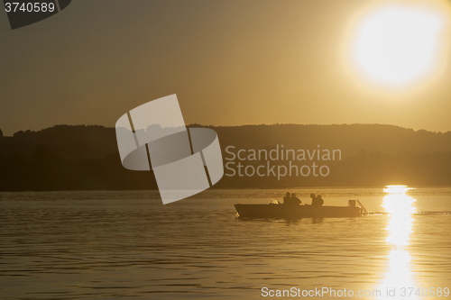 Image of Motor boat, sunset at the lake