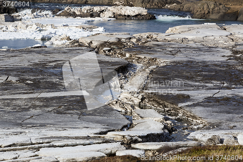 Image of Glacial ice float away on a river bank, Iceland