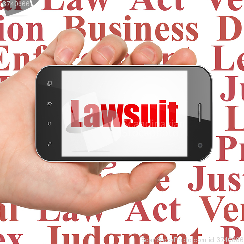 Image of Law concept: Hand Holding Smartphone with Lawsuit on display