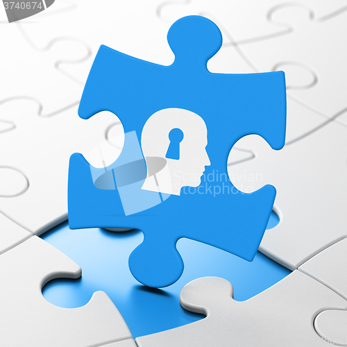 Image of Advertising concept: Head With Keyhole on puzzle background