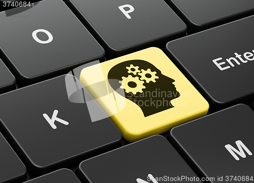 Image of Finance concept: Head With Gears on computer keyboard background