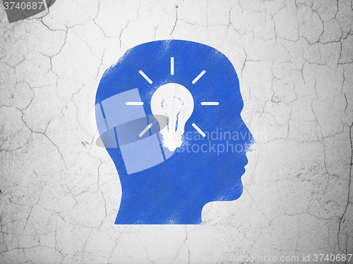 Image of Education concept: Head With Light Bulb on wall background