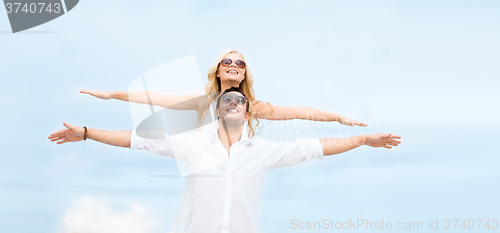 Image of couple holding hands up at sea side