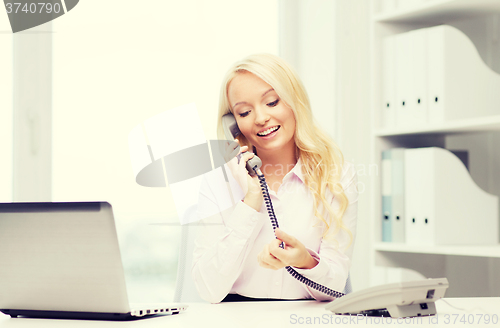 Image of smiling businesswoman or student calling on phone