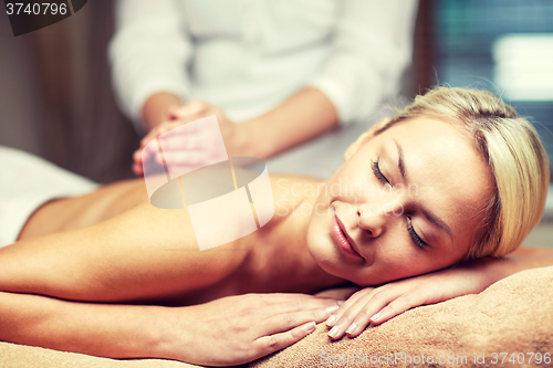 Image of close up of woman lying and having massage in spa