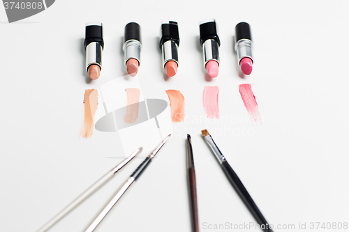 Image of close up of lipsticks range with makeup brushes