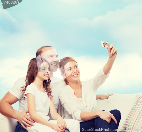 Image of happy family with camera at home