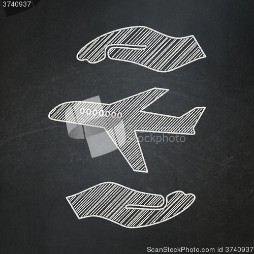 Image of Insurance concept: Airplane And Palm on chalkboard background