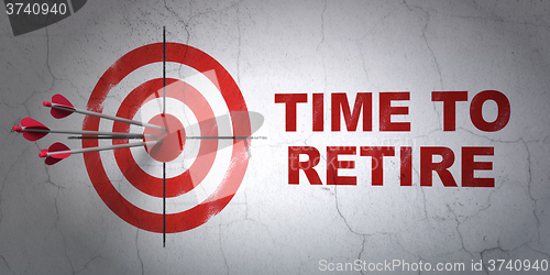 Image of Time concept: target and Time To Retire on wall background