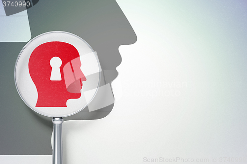 Image of Advertising concept:  Head With Keyhole with optical glass on digital background