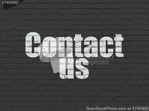 Image of Advertising concept: Contact Us on wall background