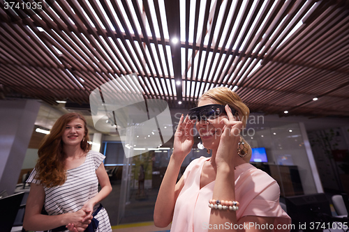 Image of woman using virtual reality gadget computer glasses