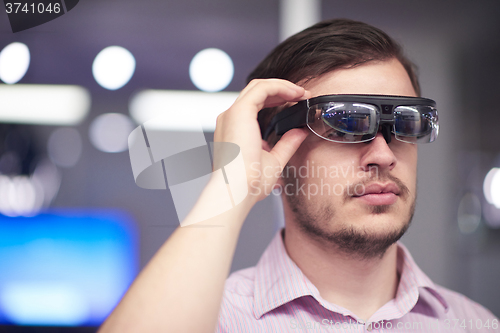 Image of man using virtual reality gadget computer glasses