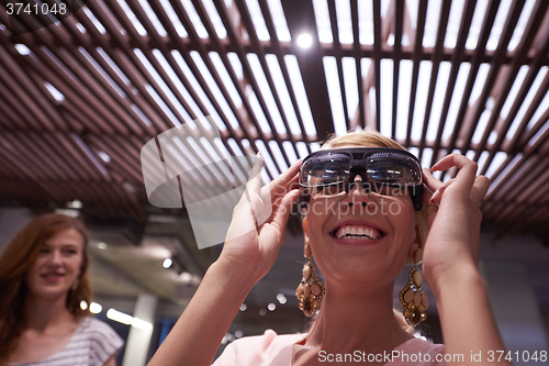Image of woman using virtual reality gadget computer glasses