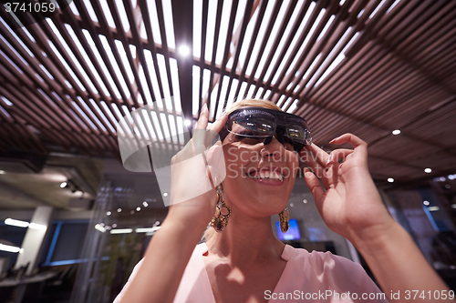 Image of woman using virtual reality gadget computer glasses