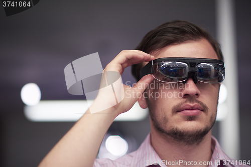 Image of man using virtual reality gadget computer glasses