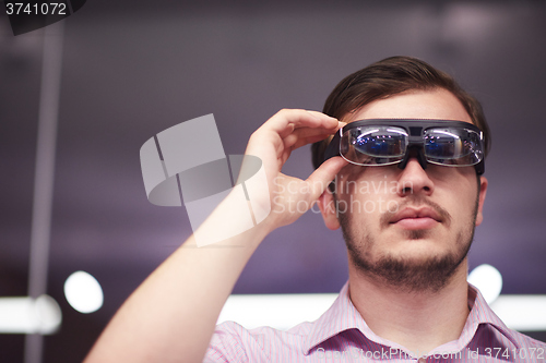 Image of man using virtual reality gadget computer glasses