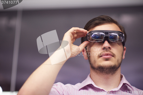 Image of man using virtual reality gadget computer glasses