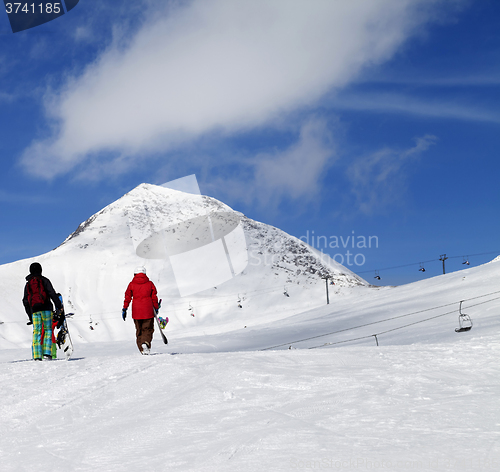 Image of Snowboarders on slope at sun nice day