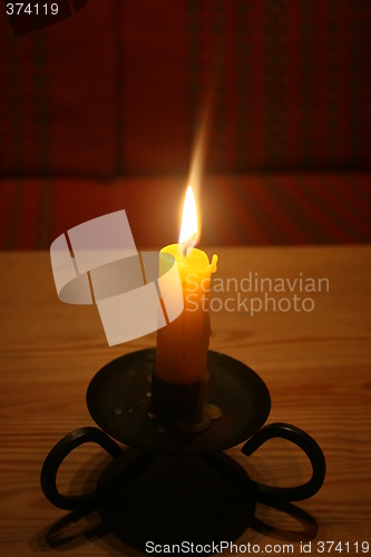 Image of Burning candle on a table