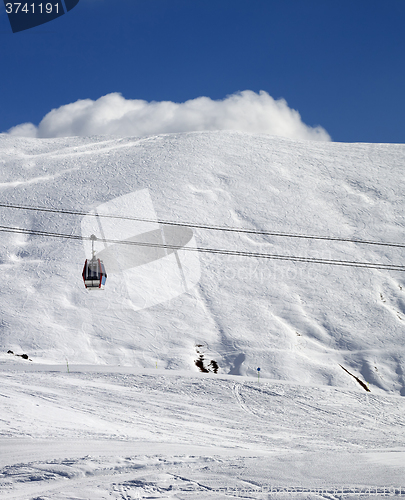 Image of Gondola lift and ski slope at sun day