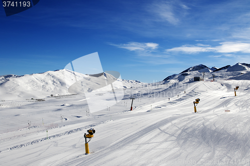 Image of Ski slope with snowmaking at sun day