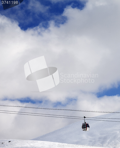 Image of Gondola lift and off-piste slope at sun day