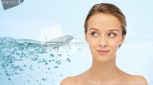 Image of smiling young woman face and shoulders