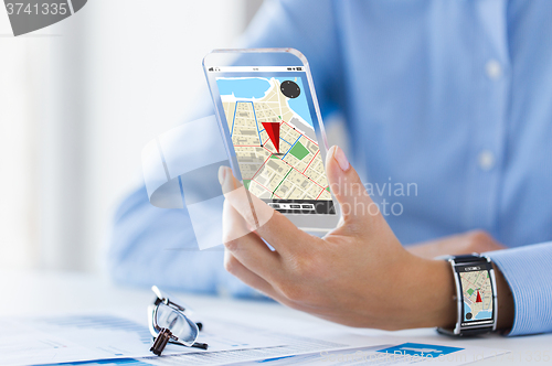 Image of hand with navigator map on smart phone and watch