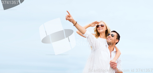 Image of couple in shades at sea side