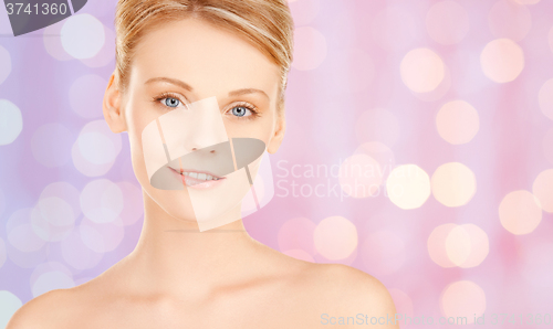 Image of lovely woman face over pink lights background